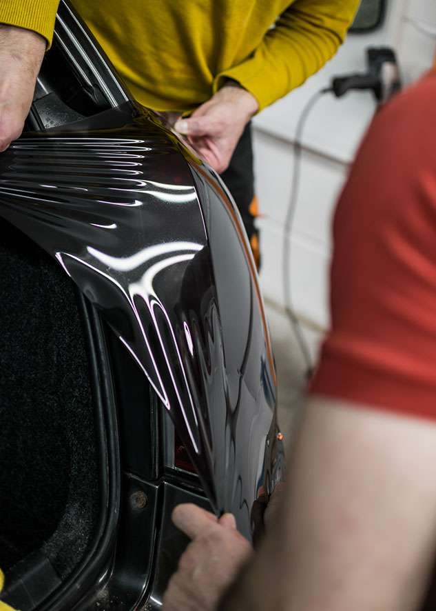 Stretching LUXE Light tinting film onto Fiat Stilo car left side rear light