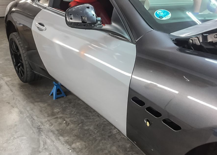 Maserati GranTurismo car being vinyl wrapped in khaki green