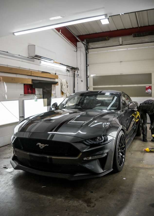 Grey Mustant GT car with shiny paintwork after polishing
