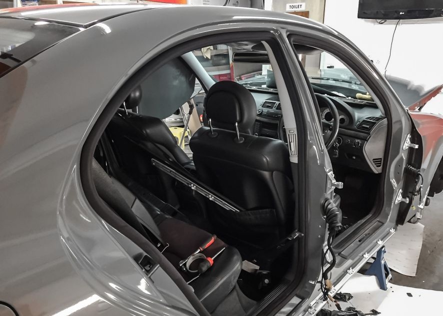 Mercedes E55 AMG being vinyl wrapped in nardo grey