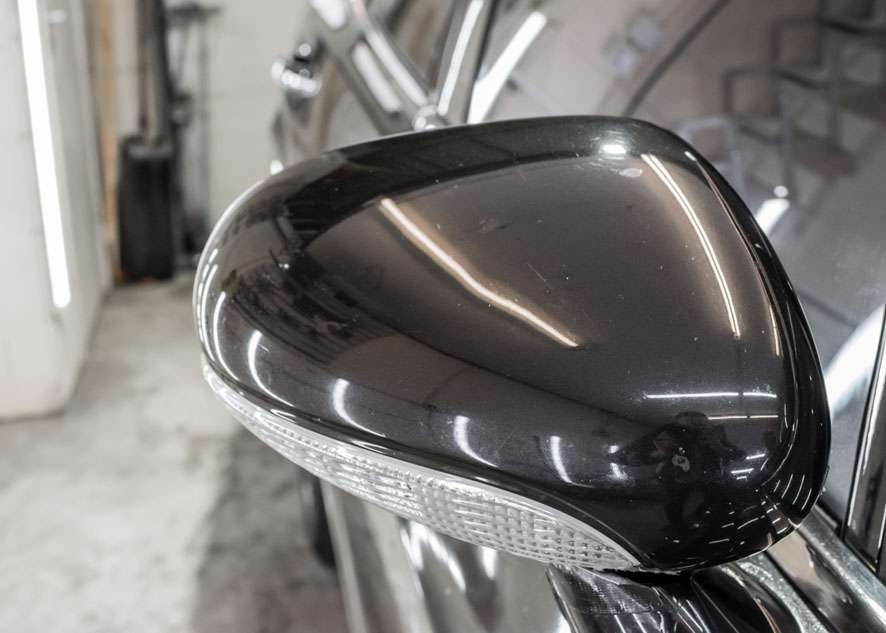 Close up shot of Bentley Flying Spur side mirror with scratches