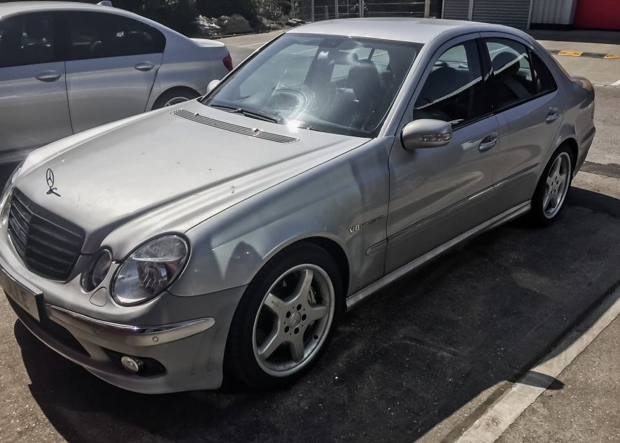 Mercedes E55 AMG being vinyl wrapped in nardo grey