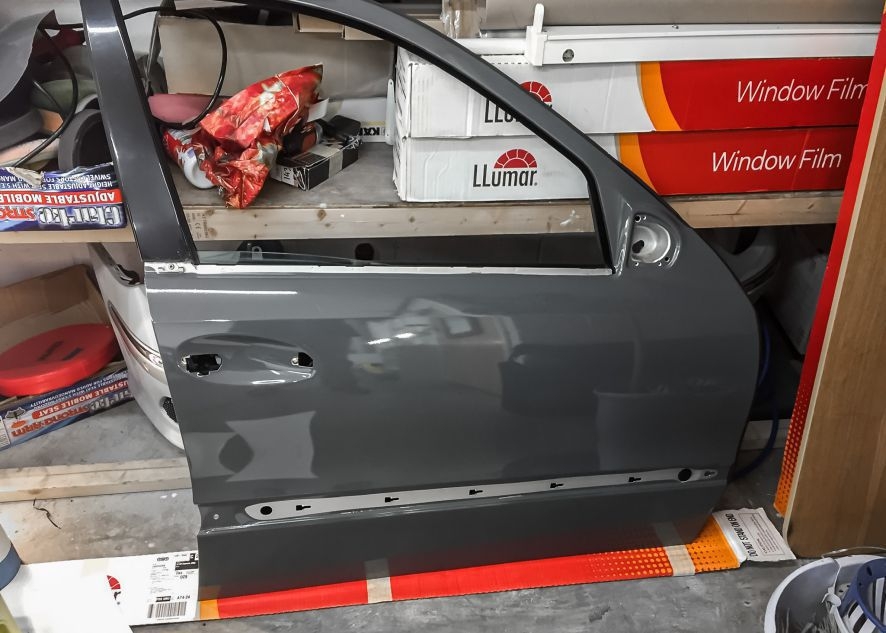 Mercedes E55 AMG being vinyl wrapped in nardo grey