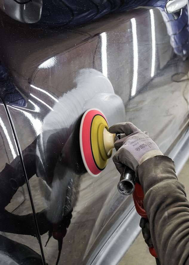 Black Nissan Juke car paintwork being machined polished to remove scratches