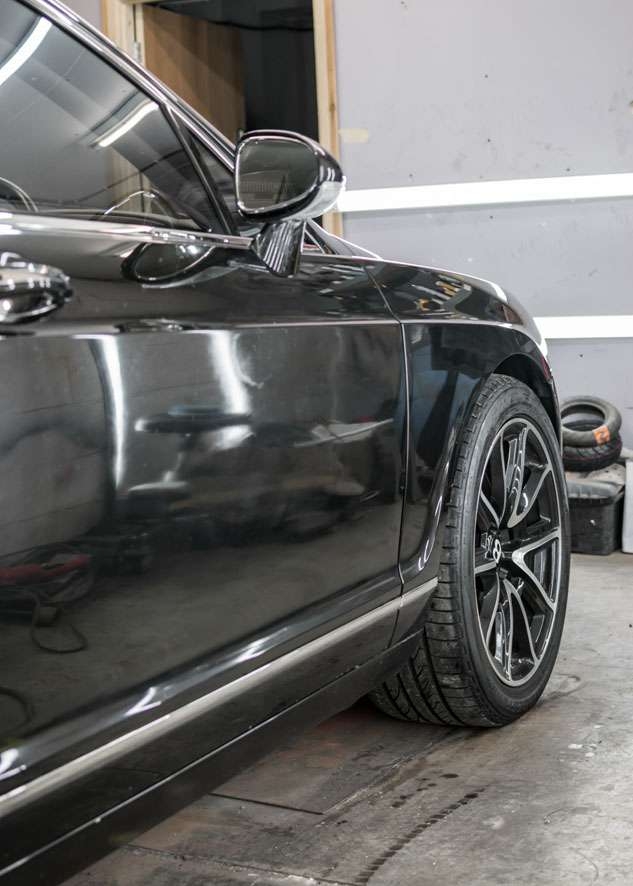 Front side shot of Bentley Flying Spur car with poor/bad/dull paint job and before paint correction