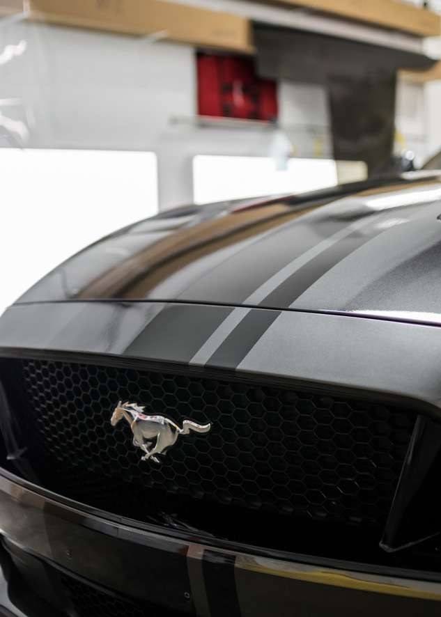 Front of car grey Mustang GT with decal stripes