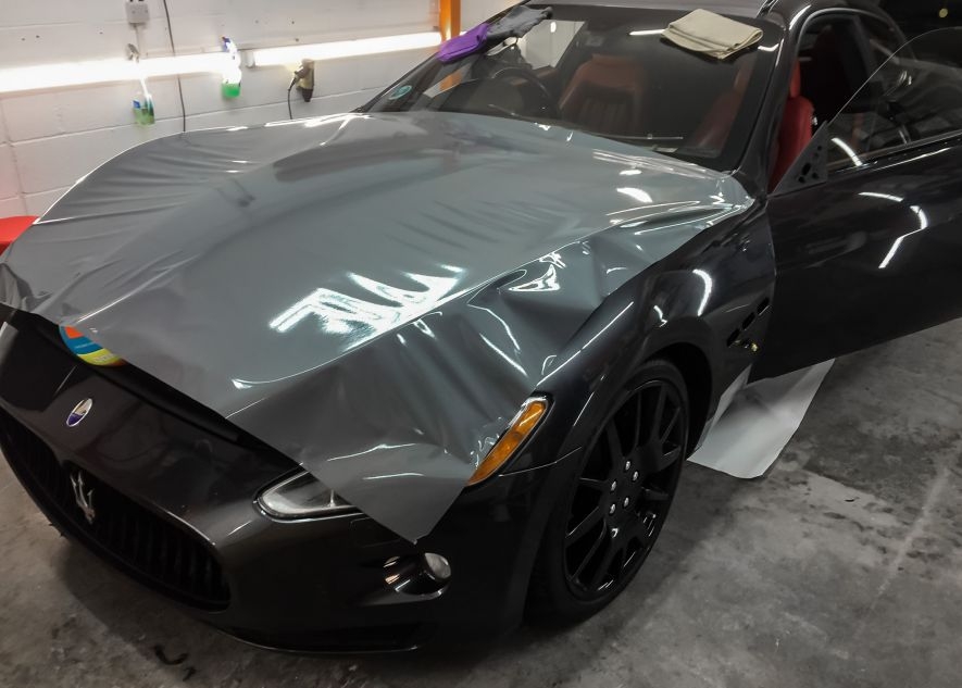 Maserati GranTurismo car being vinyl wrapped in khaki green