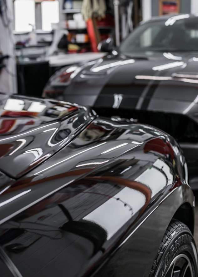 Shiny bonnet of Bentley Flying Spur car after scratches removed by polishing, paint correction and Paintwork Enhancement