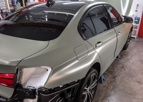 BMW 3 series car being vinyl wrapped in khaki green