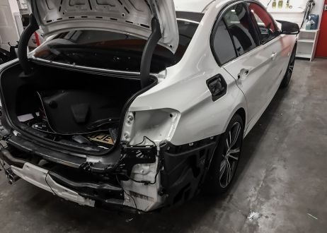BMW 3 series car being vinyl wrapped in khaki green