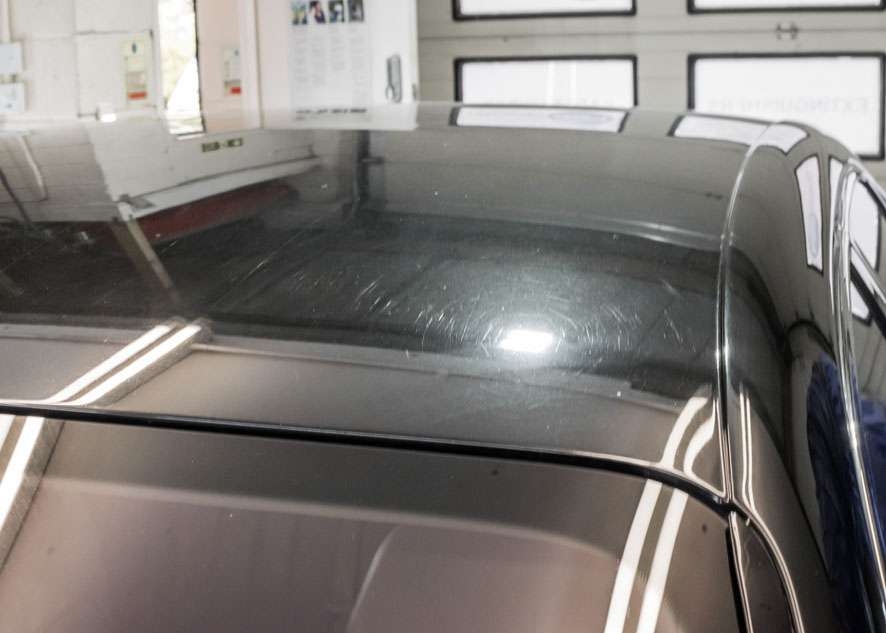 Close up shot of Bentley Flying Spur car with scratches and swirls on roof