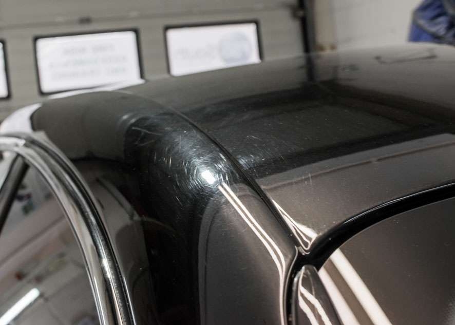 Close up shot of Bentley Flying Spur car with scratches and swirls on roof