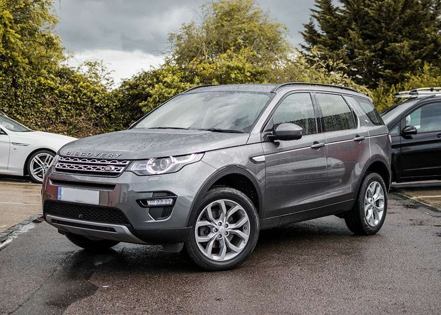 Grey Land Rover Defender with untinted windows before window tinting