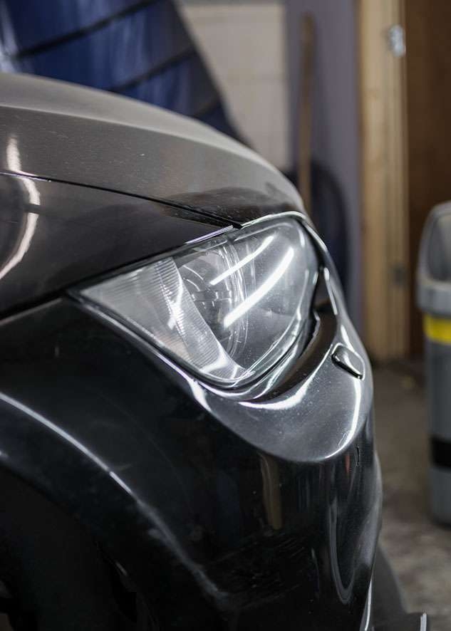 Close up shot of right side BMW 3 series car with poor/bad/dull paint job before polishing