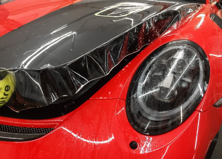 Paint protection film application on Porsche 911 GT2RS red car