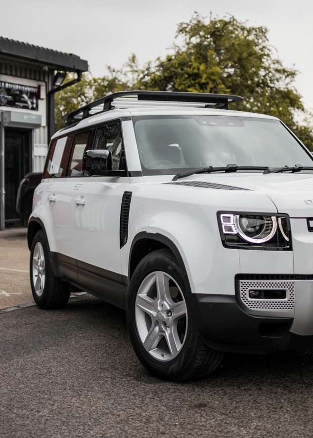 White Land Rover Defender with untinted windows before window tinting
