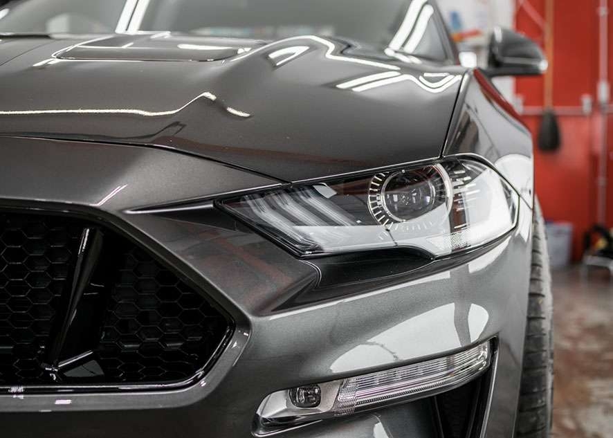 Front of Grey Mustant GT car with shiny paintwork after paint correction