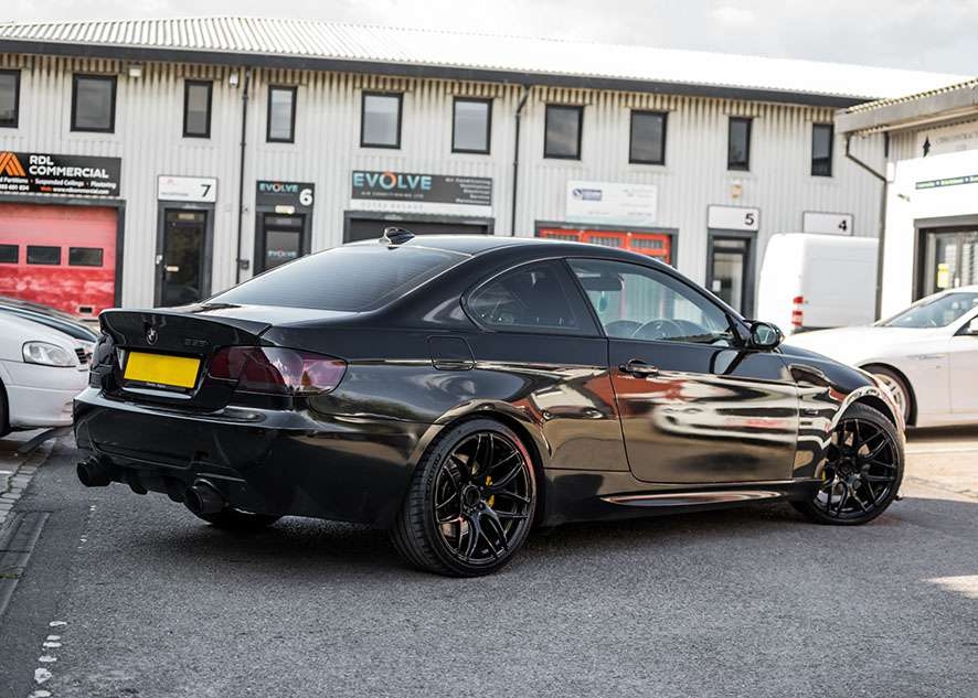 Black BMW 335i rear after polishing, paintwork correction, lights tinting, wheels spray black, wheel restoration and caliper painted yellow