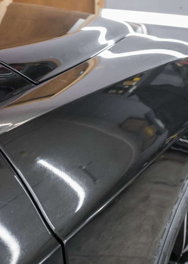 Close up shot of Bentley Flying Spur car with scratches on front wing