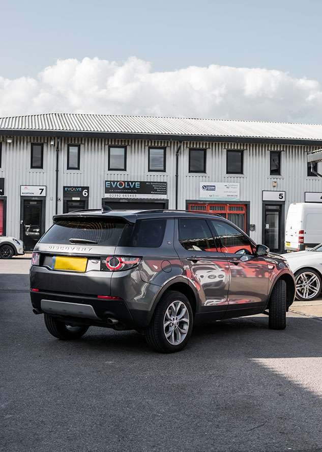 Grey Land Rover Defender with tinted rear windows after window tinting