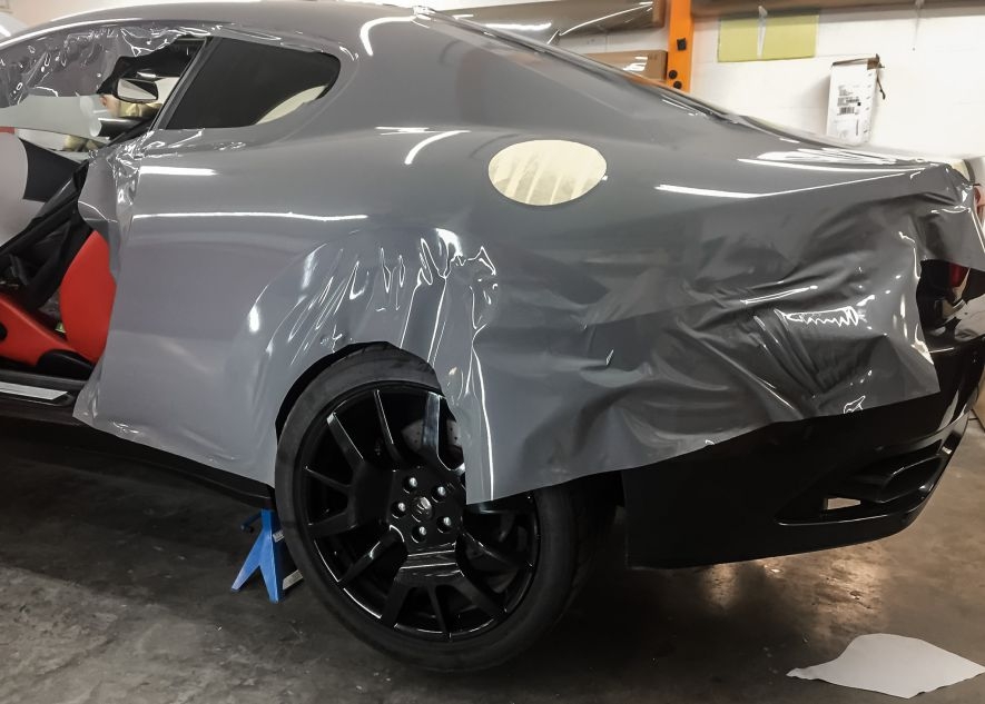 Maserati GranTurismo car being vinyl wrapped in khaki green