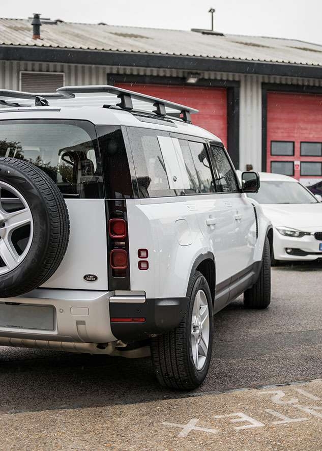 White Land Rover Defender with untinted windows before window tinting