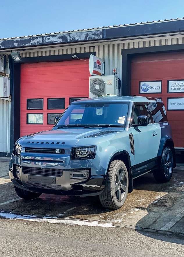 Blue Land Rover Defender roof being taken apart