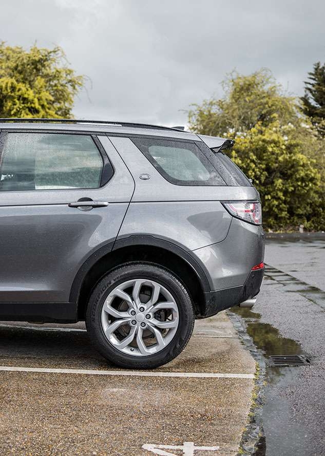 Grey Land Rover Defender with untinted rear windows before window tinting