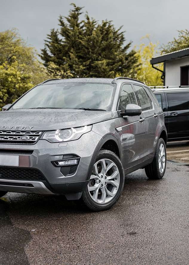 Grey Land Rover Defender with untinted windows before window tinting