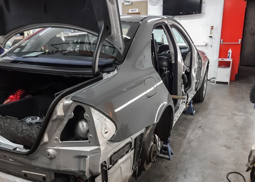 Mercedes E55 AMG being vinyl wrapped in nardo grey