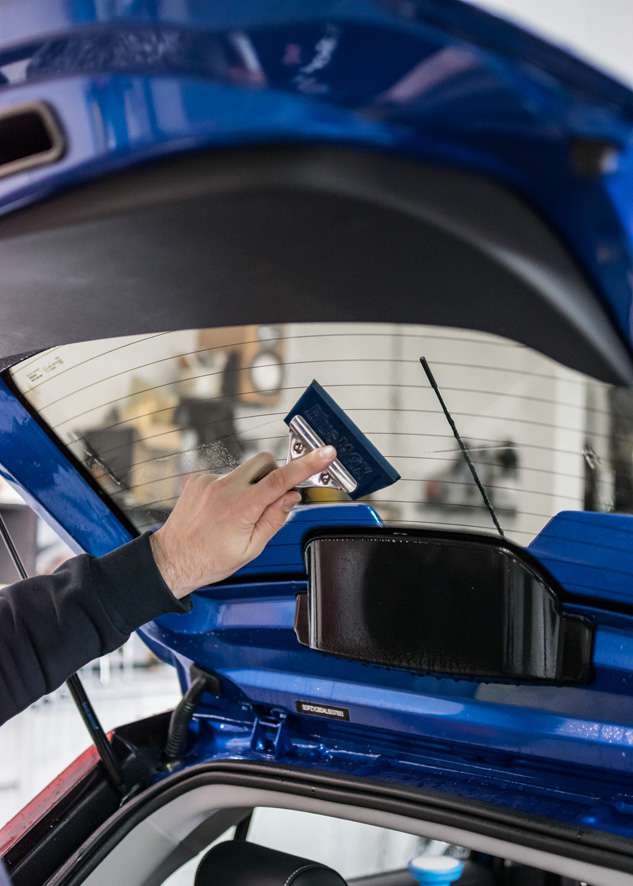 Blue MG3 car rear window being tinted