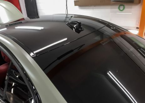 BMW 3 series car being vinyl wrapped in khaki green