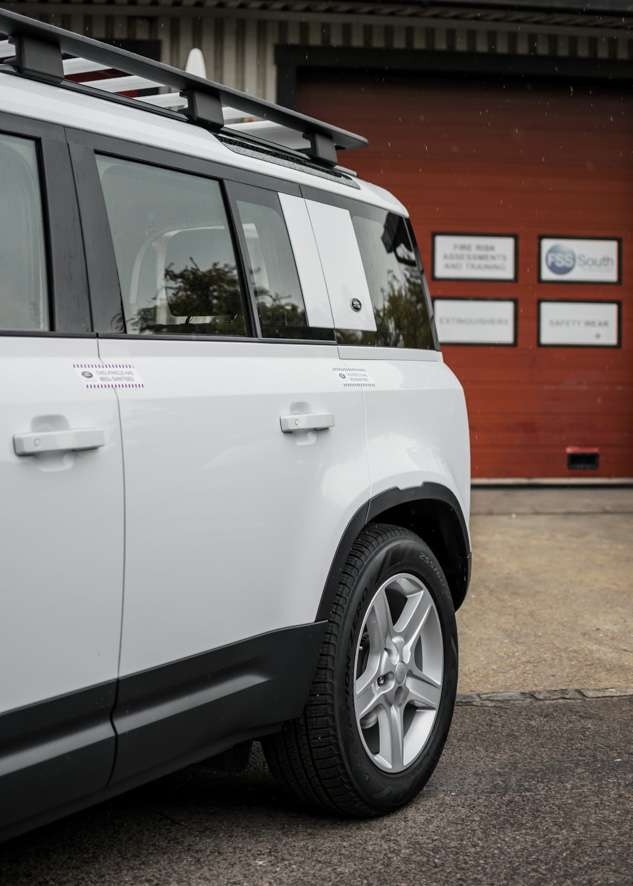 White Land Rover Defender with untinted windows before window tinting