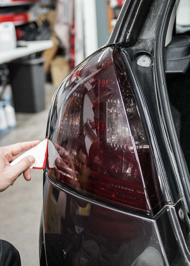 Fiat Stilo car left side rear light being tinted using LUXE Light film
