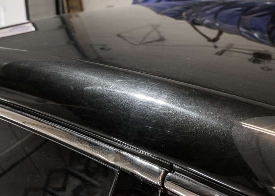 Close up shot of Bentley Flying Spur car with scratches and swirls on roof